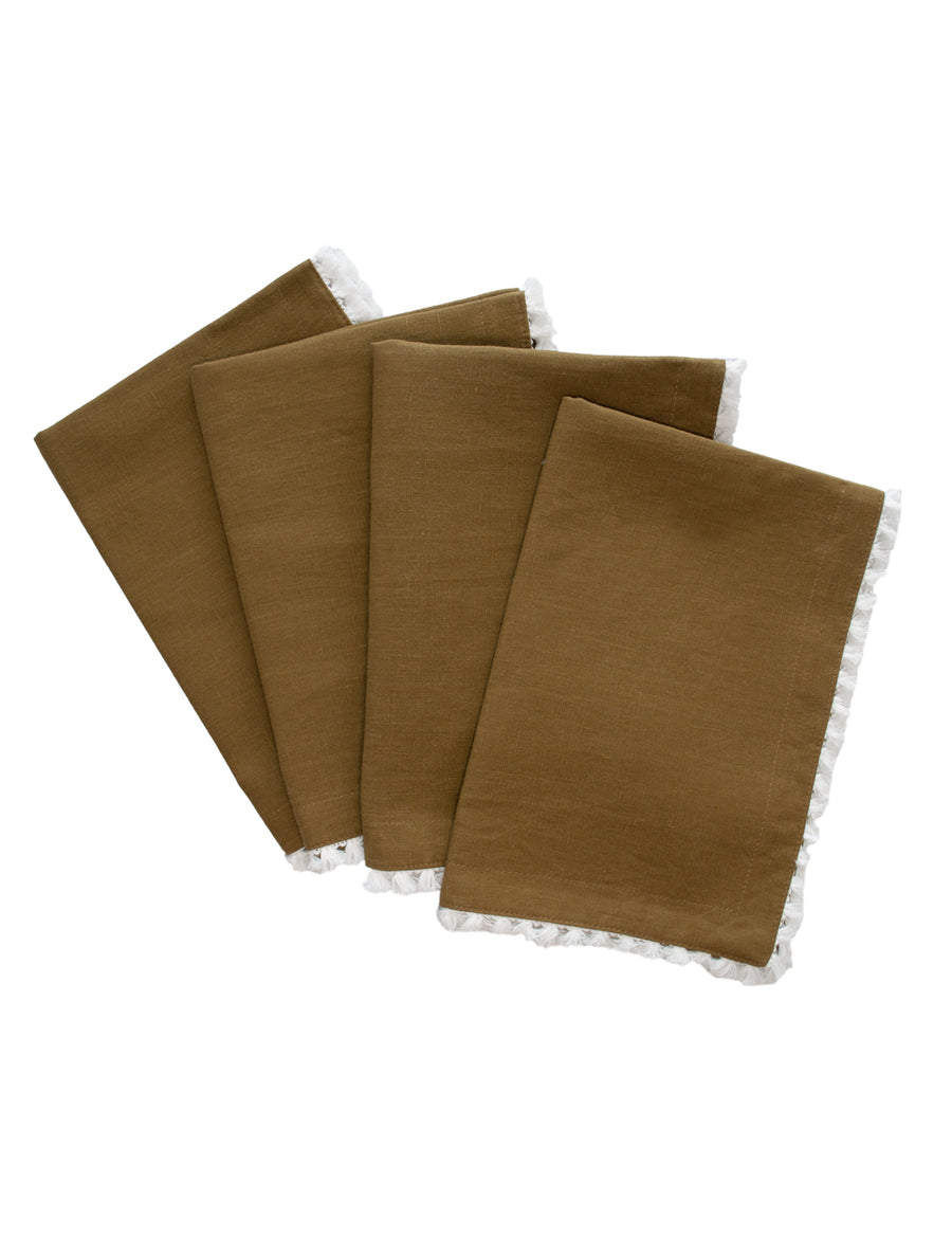 a set of linen placemat in olive colour with cotton tassel trim