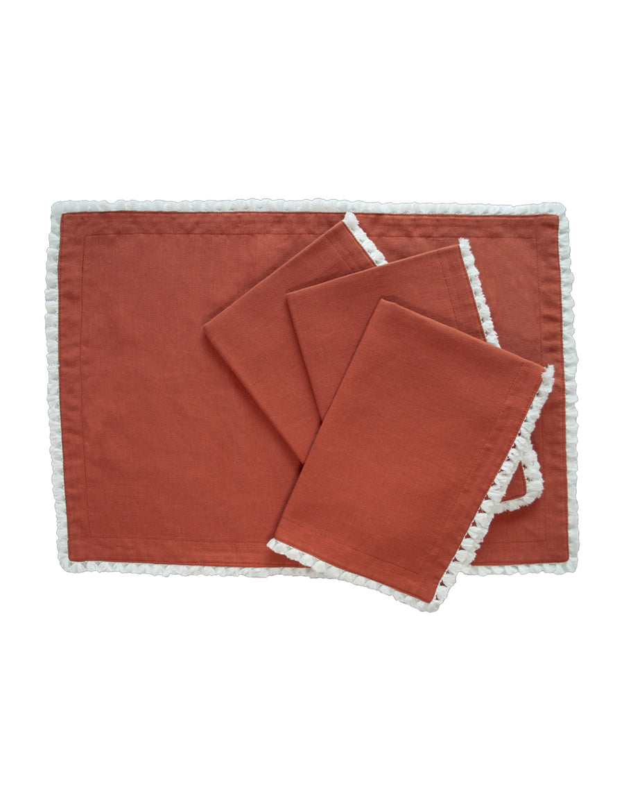 linen placemat in rust colour with cotton tassel trim