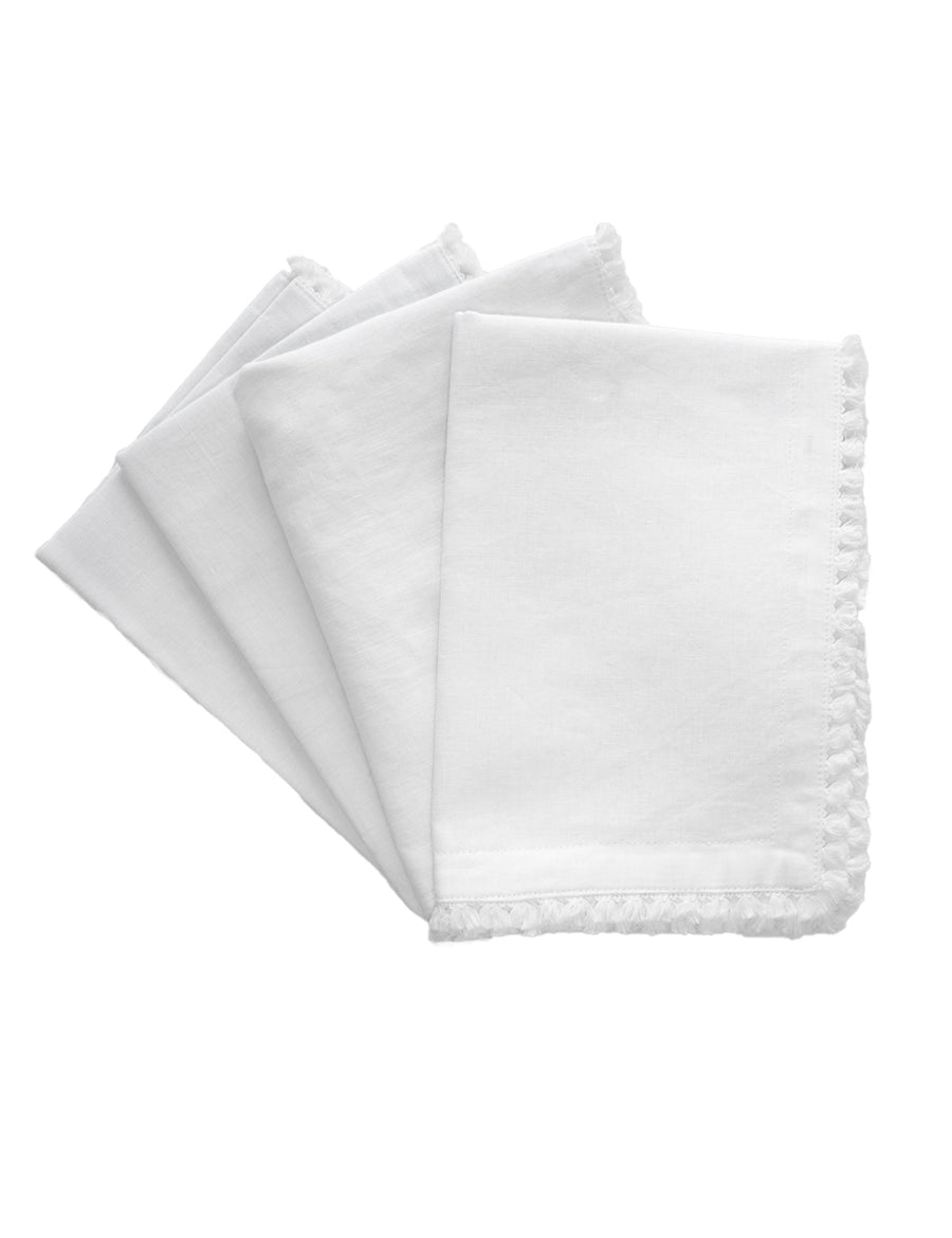 a set of linen placemat in white colour with cotton tassel trim