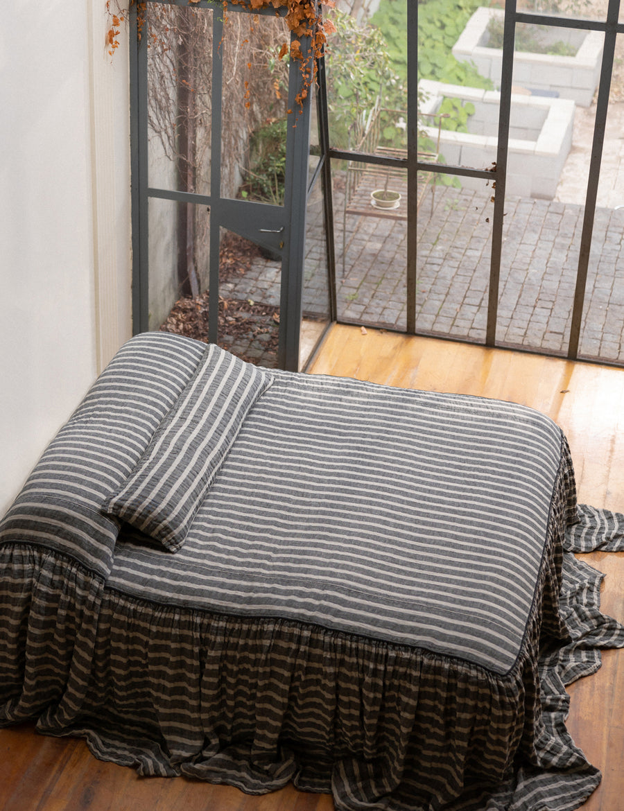 photoshoot of our charcoal natural striped linen bed cover