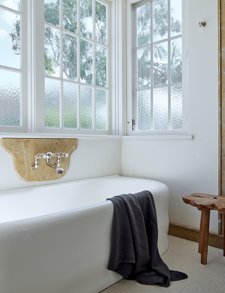 lifestyle photo of linen jacquard bath towel in charcoal colour
