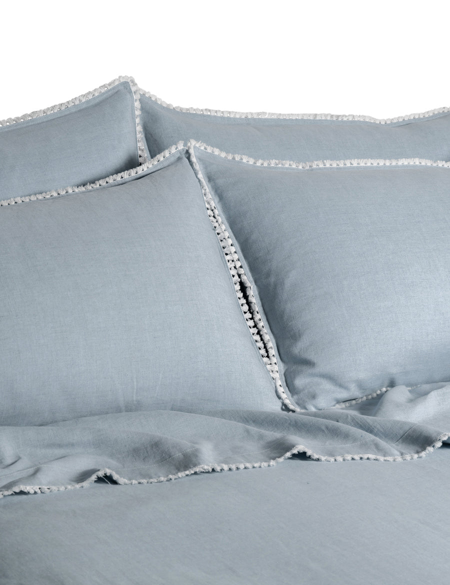 linen quilt set in cloud colour and finished in our contrast organic cotton tassel trim