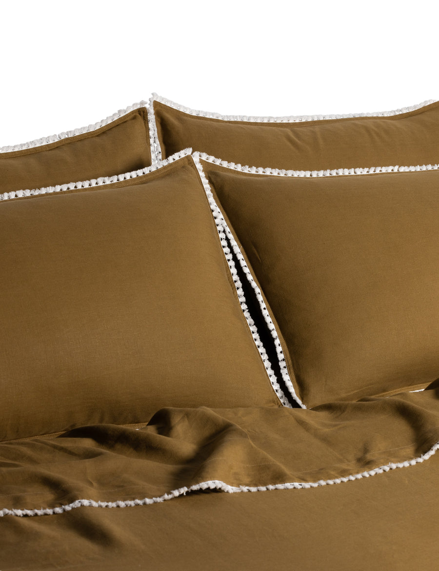 linen quilt set in olive colour and finished in our contrast organic cotton tassel trim