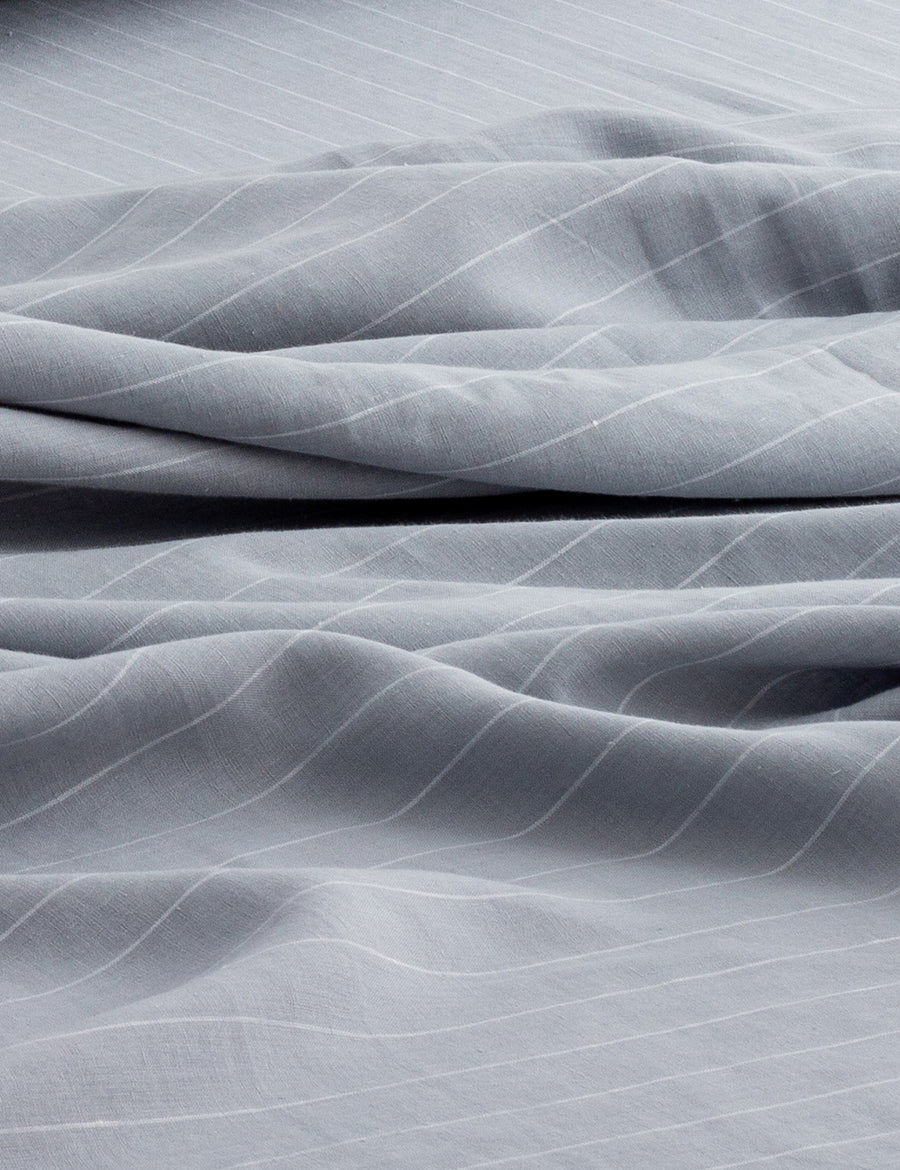 details of pinstripe linen sheet set in cloud with white stripes
