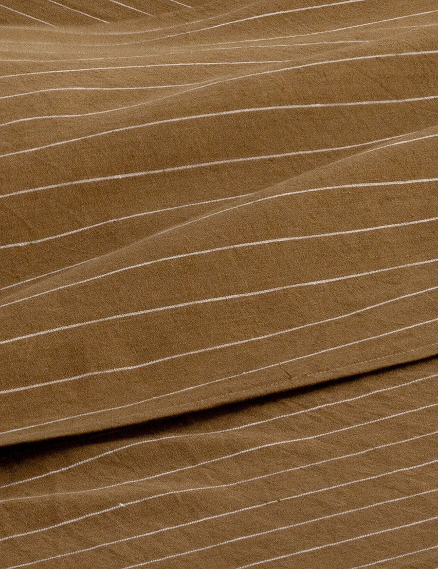 details of pinstripe linen sheet set in olive with white stripes
