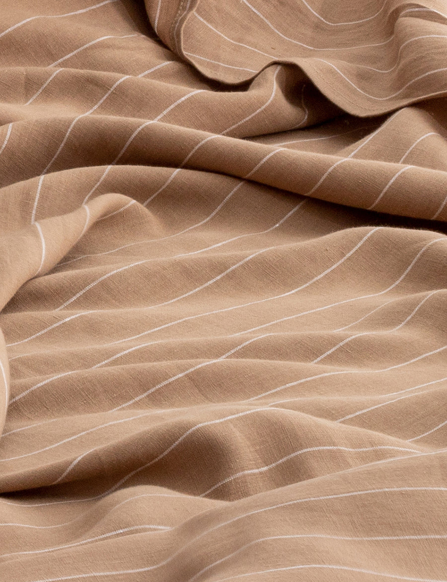 details of pinstripe linen sheet set in teak with white stripes