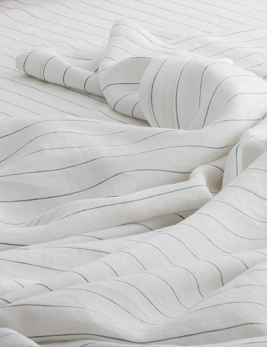 details of pinstripe linen sheet set in white with cloud stripes