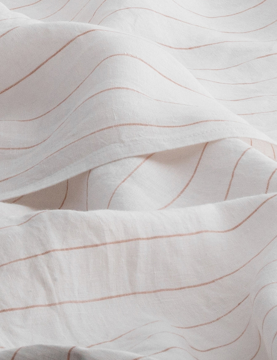 details of pinstripe linen sheet set in white with nude stripes