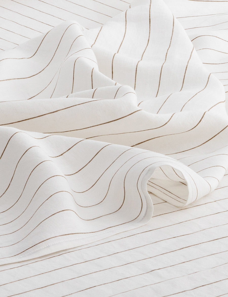 details of pinstripe linen sheet set in white with olive stripes