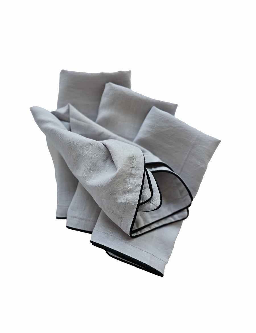 linen table napkins in cement colour with charcoal piping