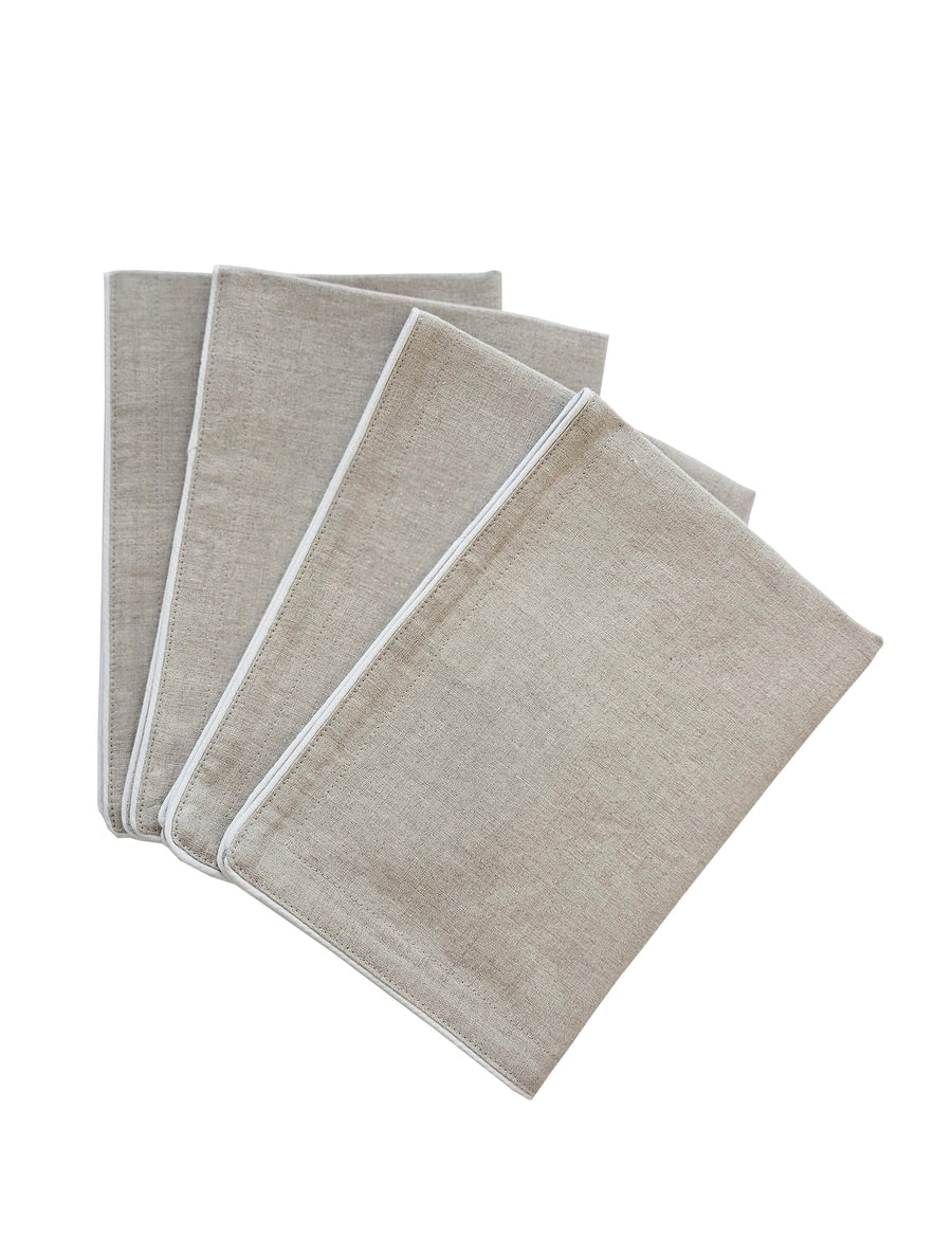 a set of piped linen placemat in natural colour