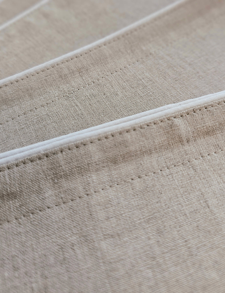 details of piped linen placemat in cloud colour