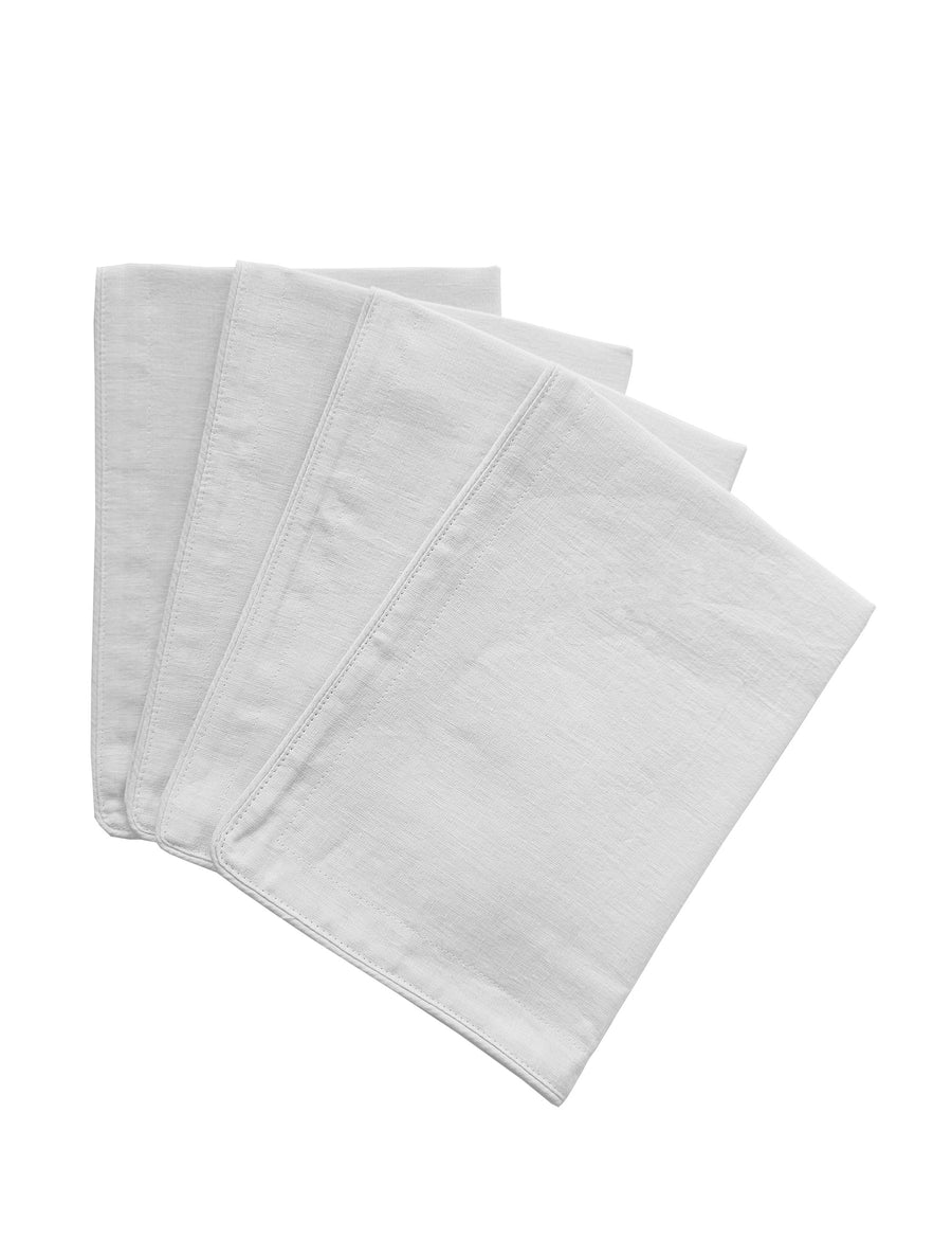 a set of piped linen placemat in white colour