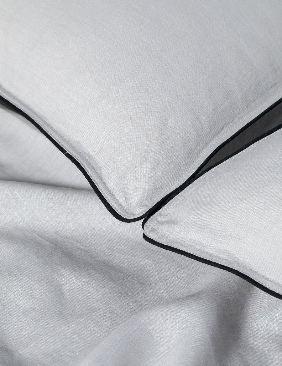 details of piped pillowcases in cement colour with contrast piping in charcoal