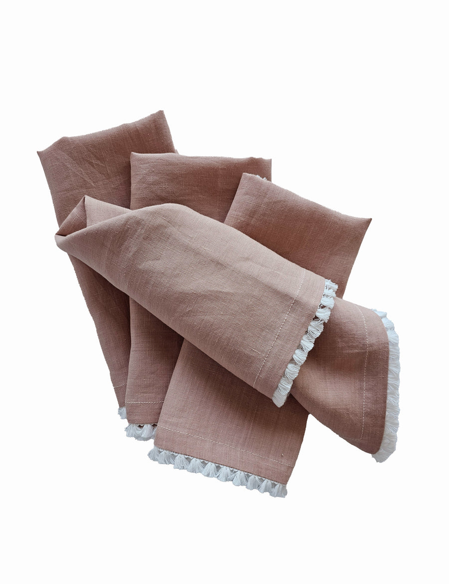 linen table napkins in blush colour with cotton tassel trim in white