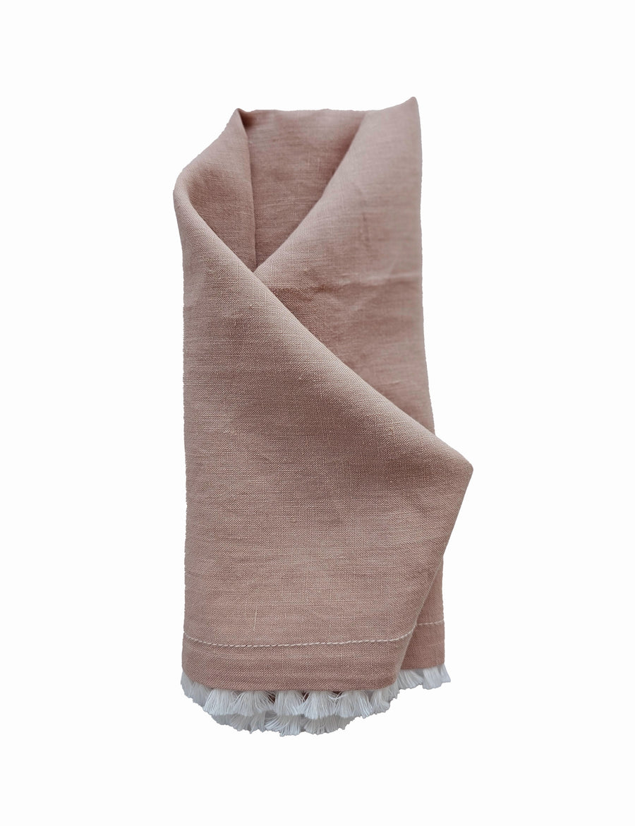 linen table napkin in blush colour with cotton tassel trim in white