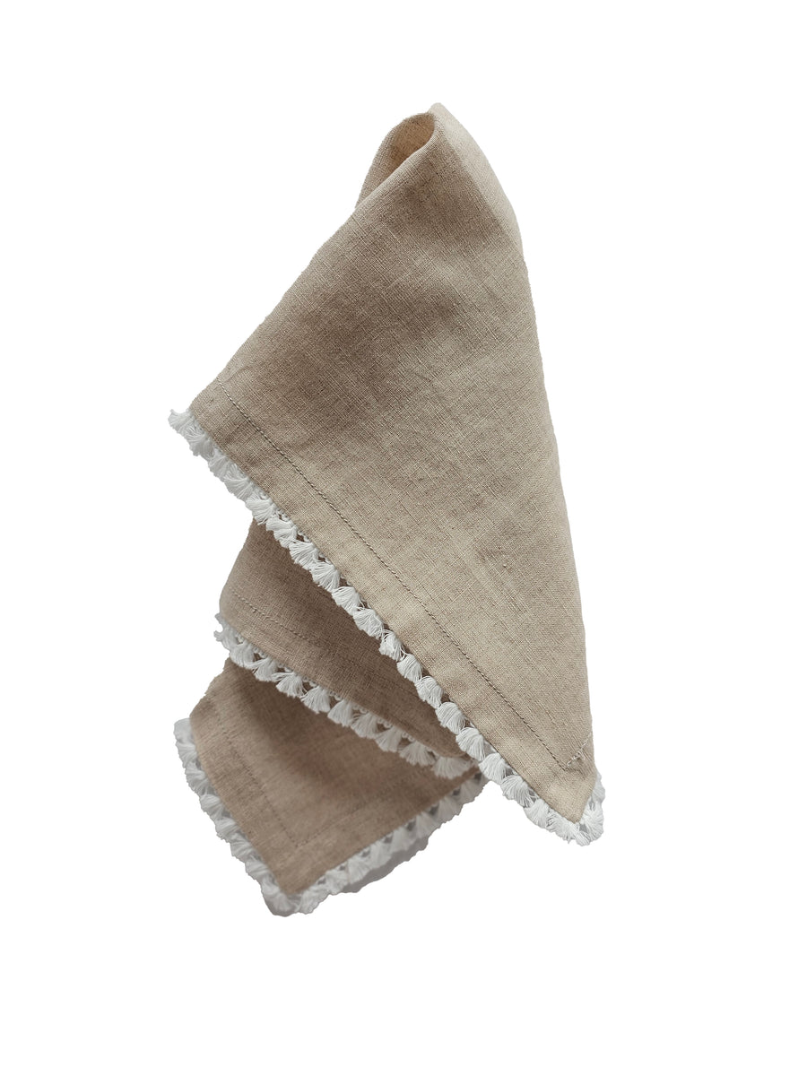 linen table napkin in natural colour with cotton tassel trim in white