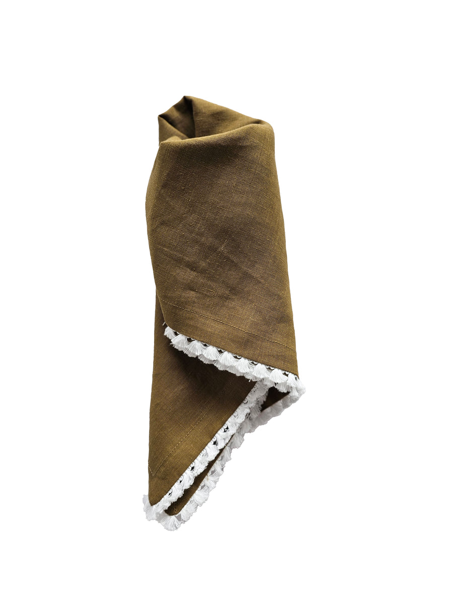 linen table napkin in olive colour with cotton tassel trim in white