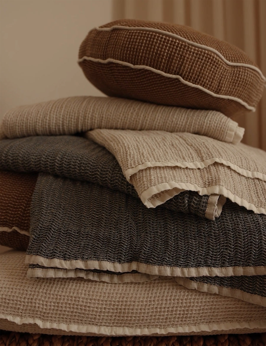 stack photos of linen cotton textured throws and pillows