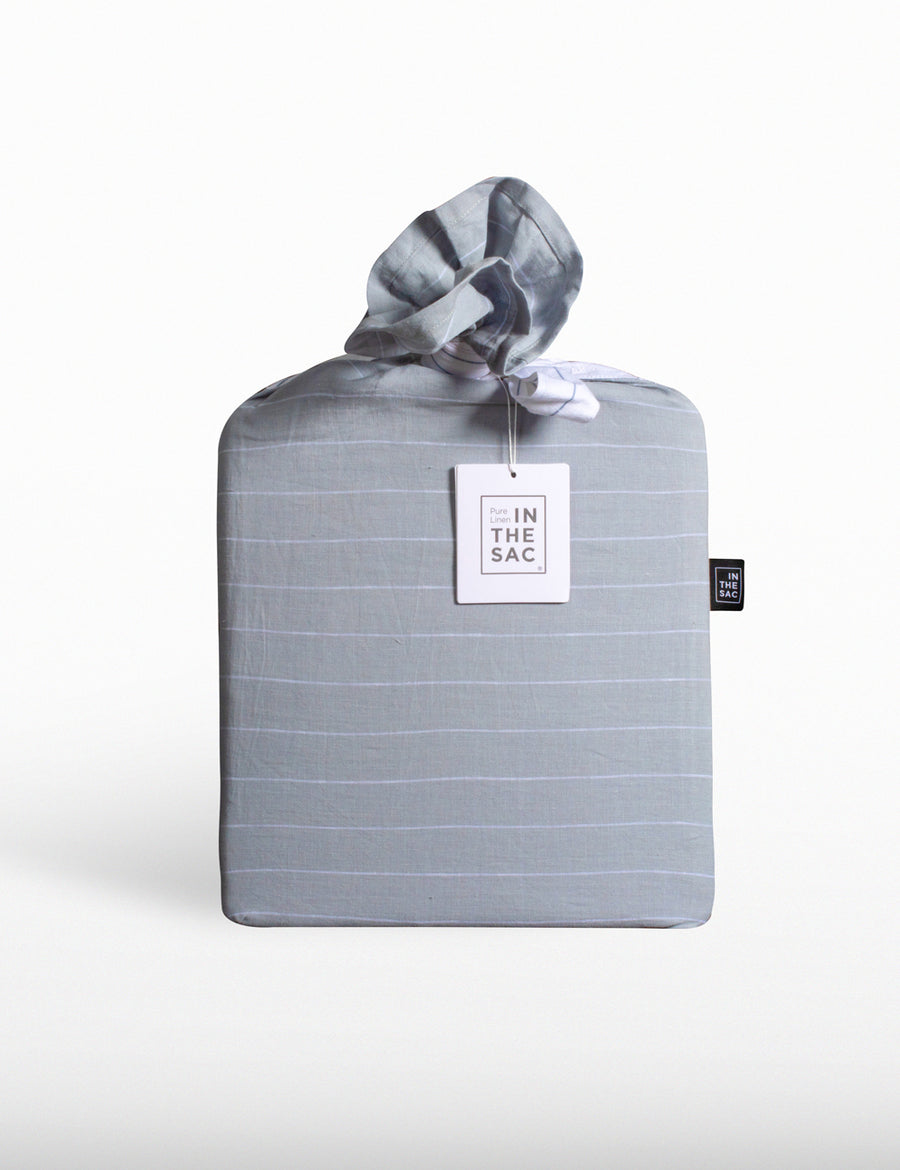the packaging of reversible pinstripe linen quilt set in cloud and white