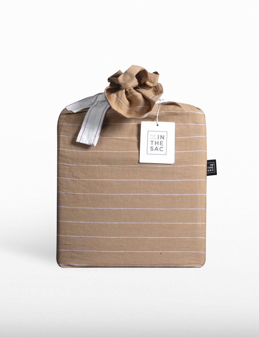 the packaging of reversible pinstripe linen quilt set in teak and white
