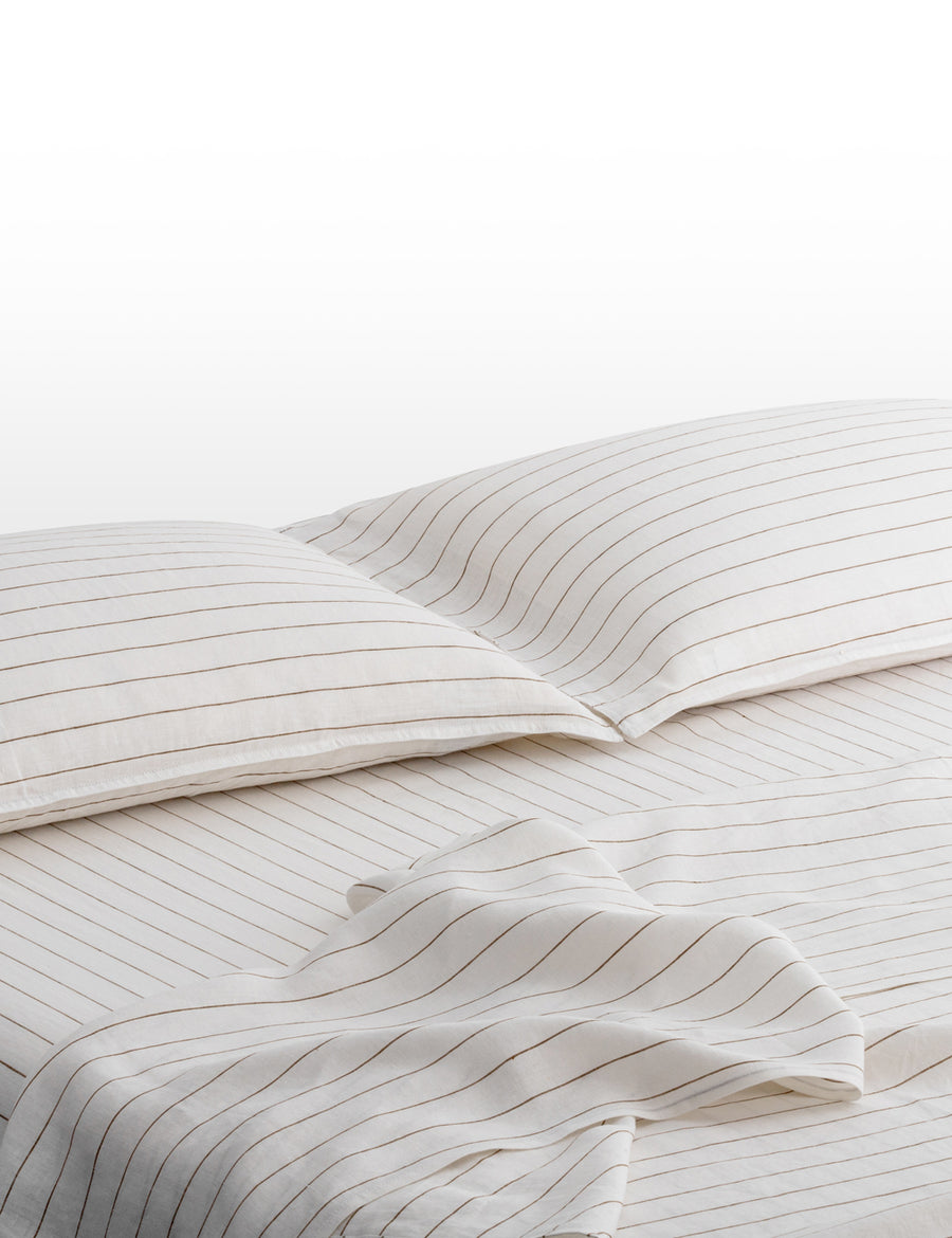 pinstripe linen sheet set in white with olive stripes