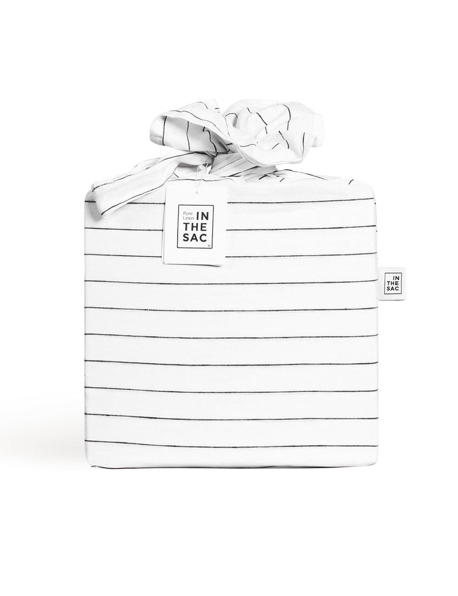 the packaging of reversible pinstripe linen quilt set in white and charcoal