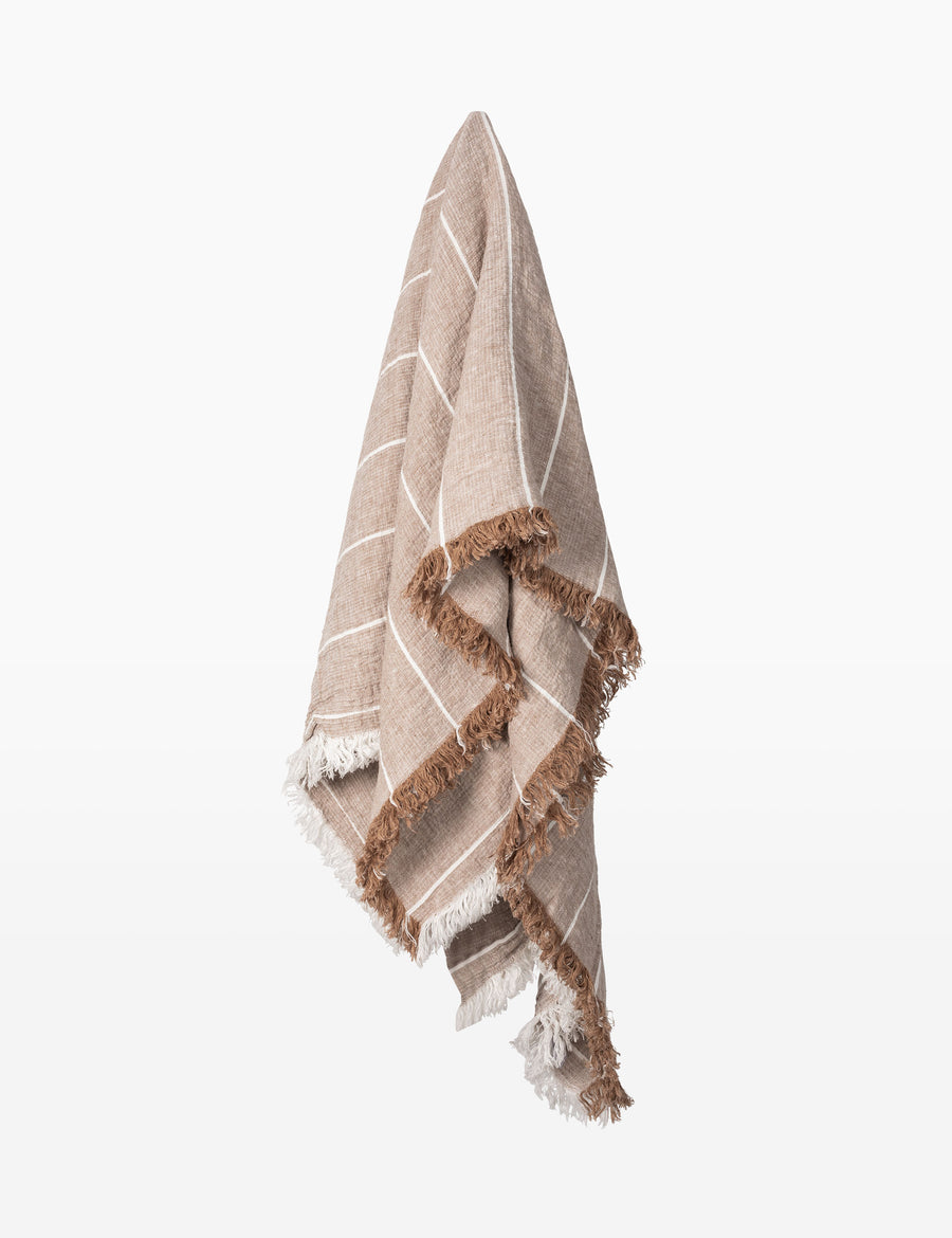 hanging photo of textured linen throw with fringe trim in stripes caramel with natural