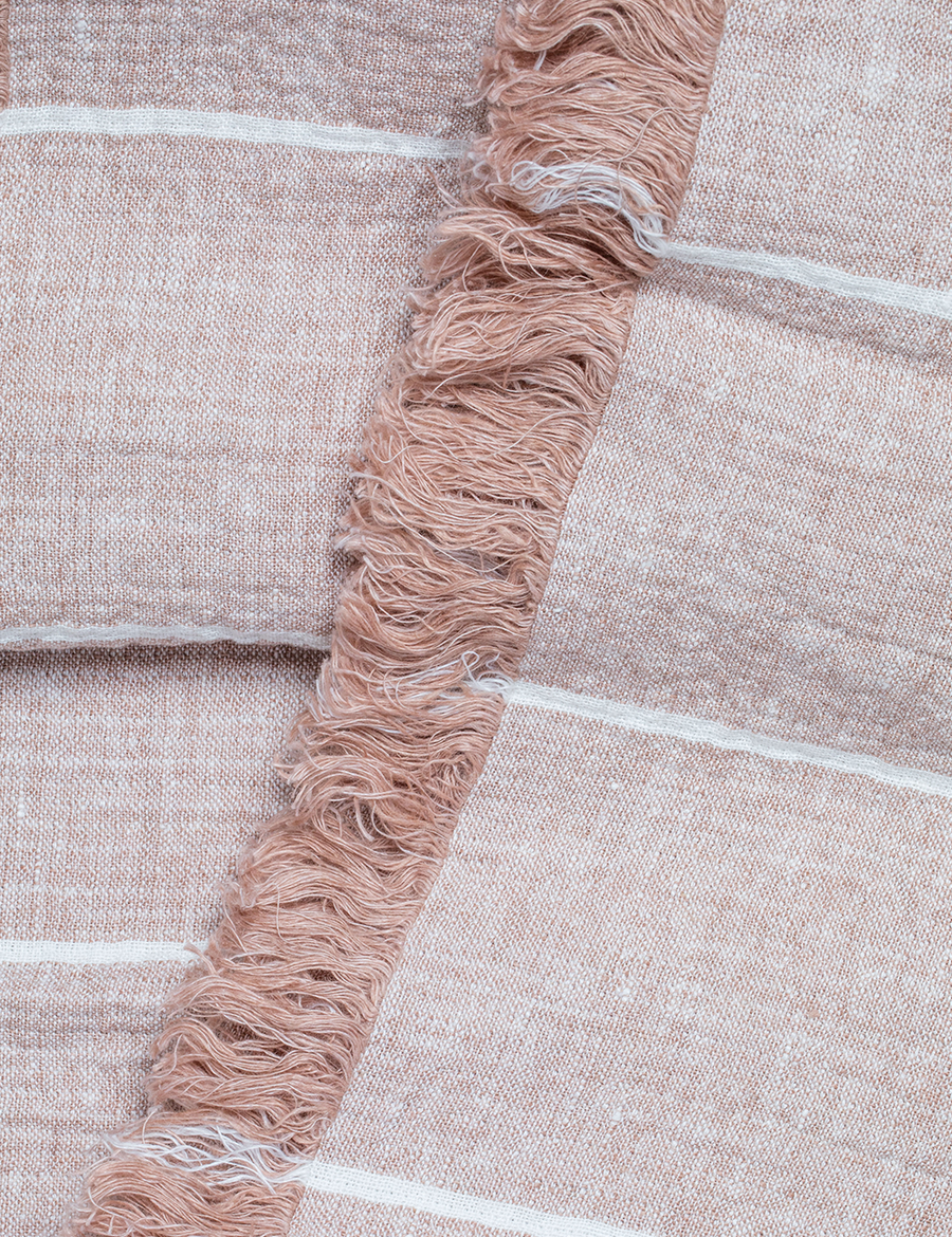detail shot of textured linen throw with fringe trim in stripes nude with ivory