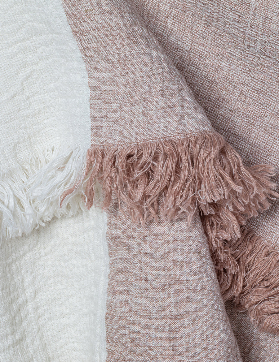 detail shot of textured linen throw with fringe trim in colour block nude with ivory
