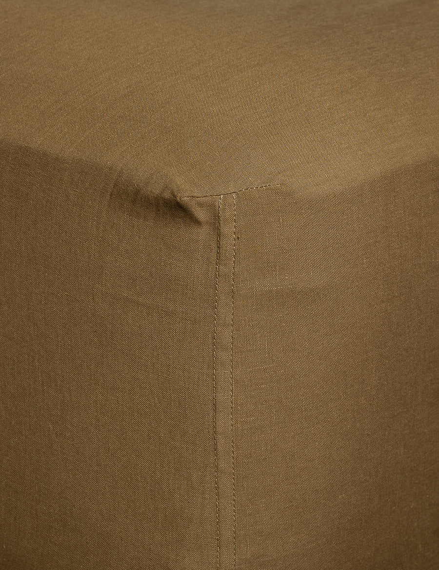 corner details of linen fitted sheet in olive colour