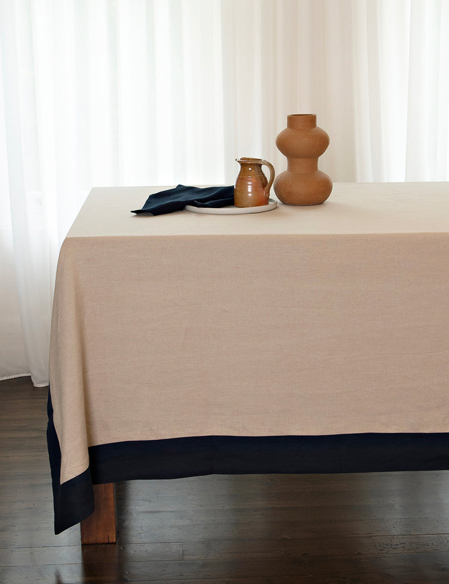reversible linen tablecloth in natural and navy with clay vase