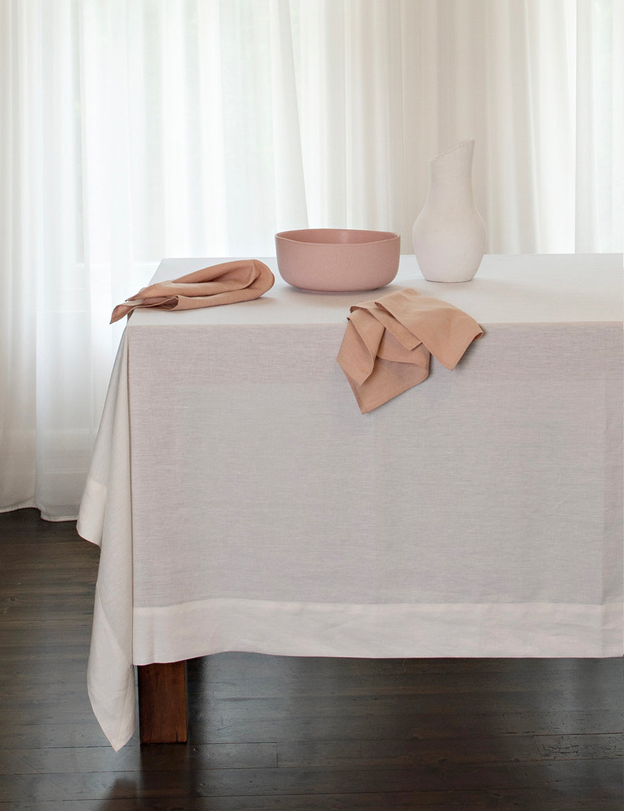 linen tablecloth in white with pink napkins and bowl