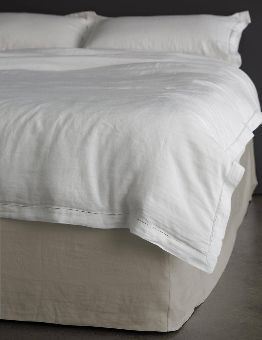 thick linen bed valance in natural colour styled with linen quilt set in white