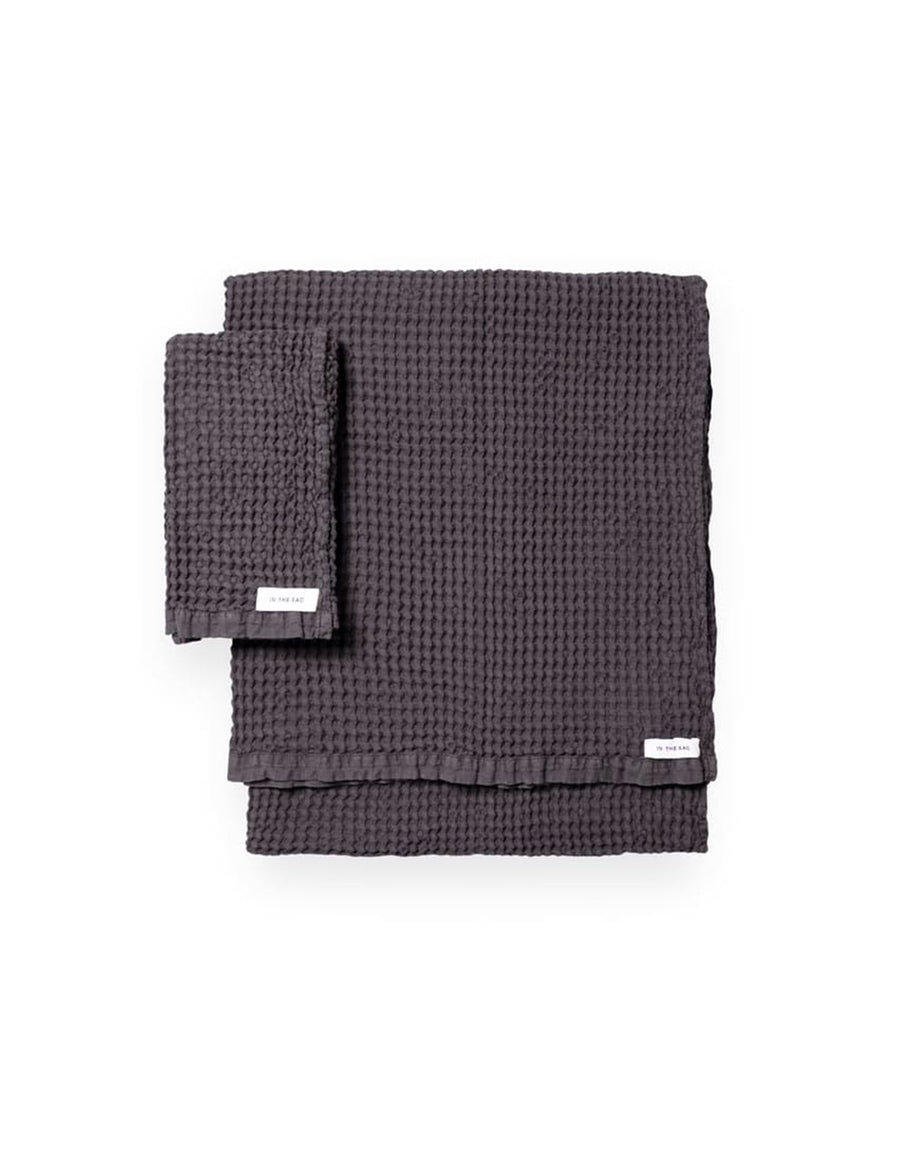 stacked photo of linen waffle hand towel in graphite colour with matching bath towel