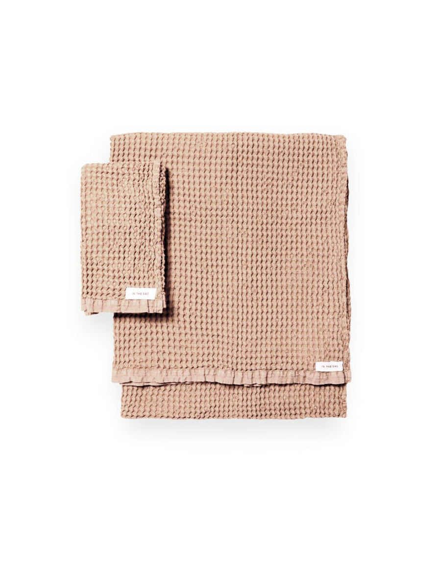 stacked photo of linen waffle hand towel in nude colour with matching bath towel