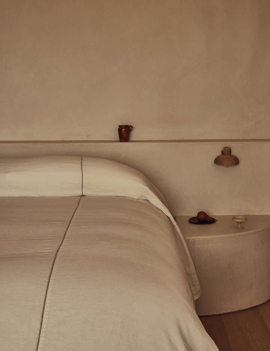 heavy-weighted linen Coverlet in fresh Ivory linen, featuring a subtle natural contrast piping detail 