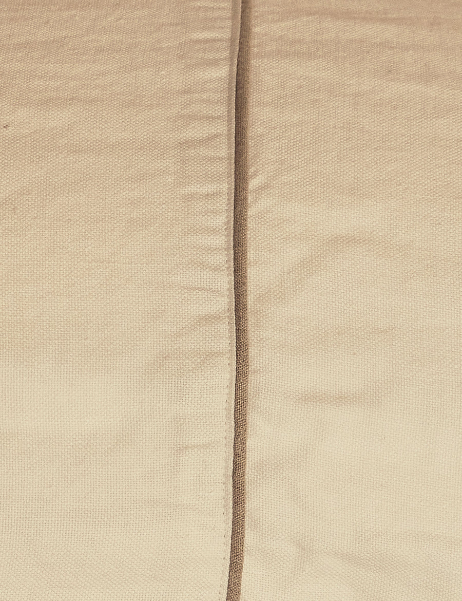 details of the piping of the ivory coverlet