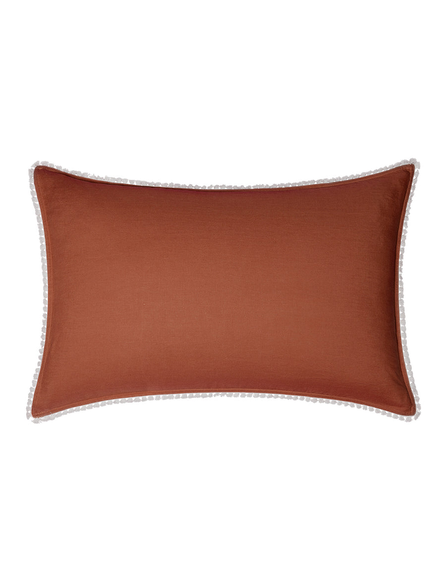 linen pillowcases with cotton tassel trim in rust colour
