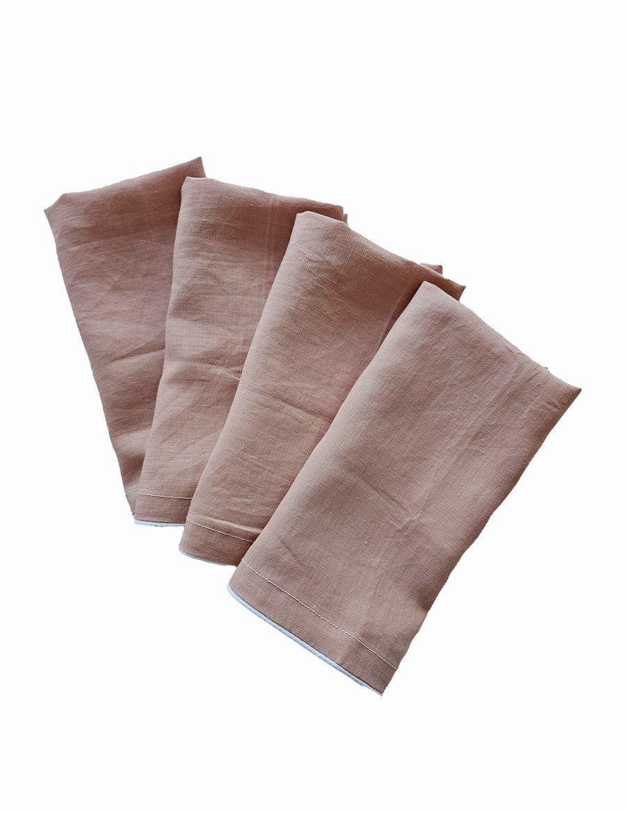 linen table napkins in blush colour with white piping