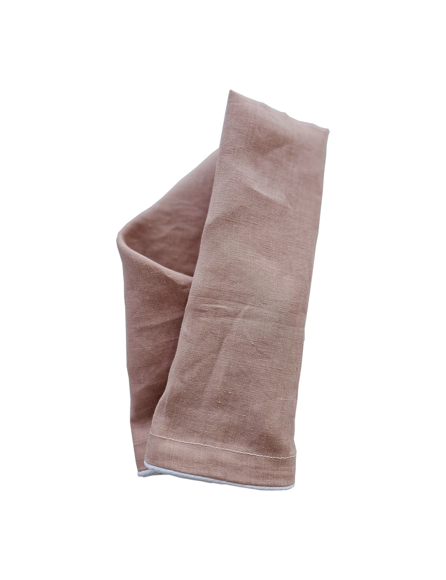 linen table napkin in blush colour with white piping