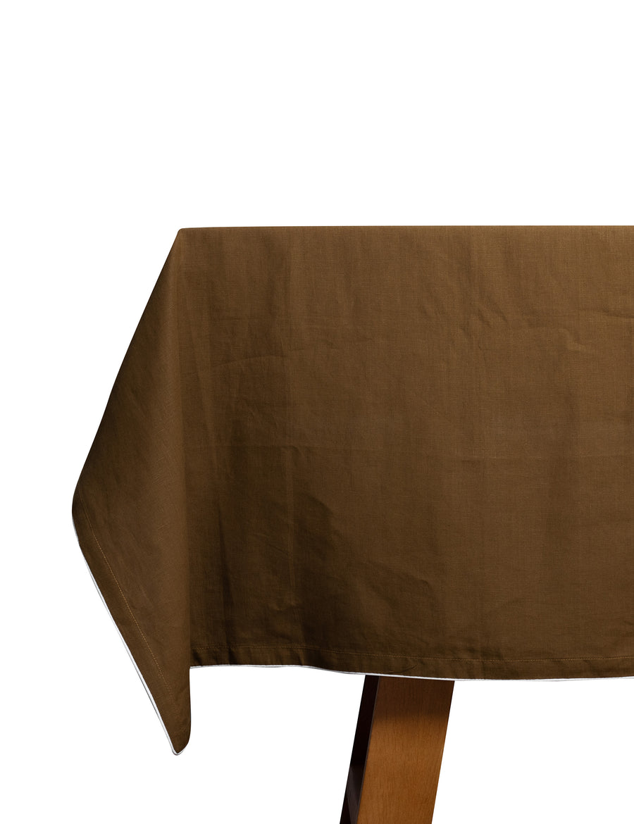 piped linen tablecloth in olive with white piping