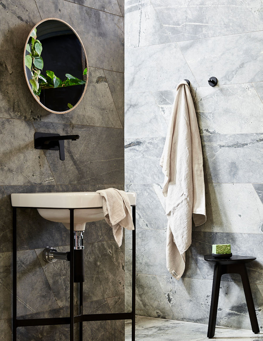 styled hanging pure linen jacquard bath towel in natural colour with matching hand towel in a modern bathroom