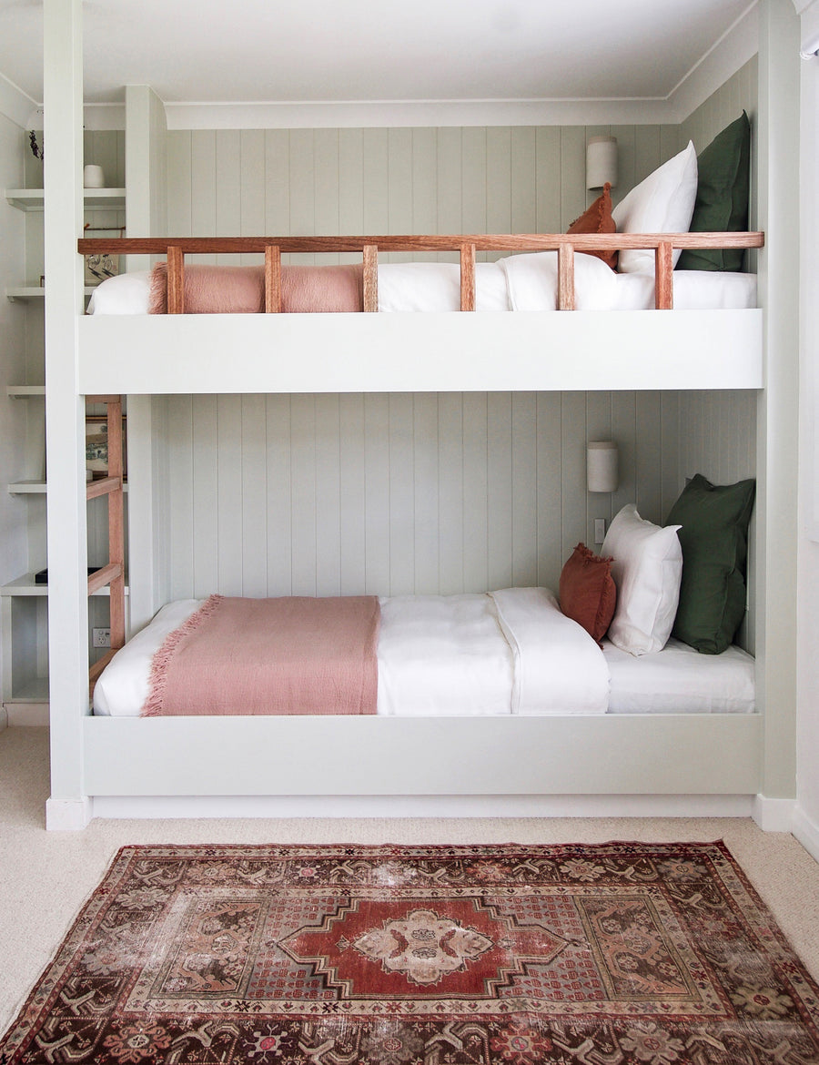 lifestyle shot of the textured linen throw in musk colour on modern bunk bed