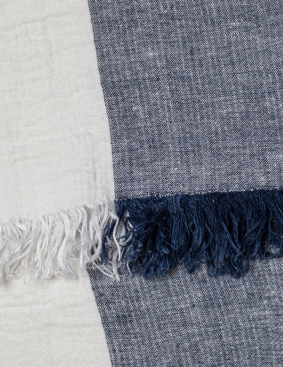 detail shot of textured linen throw with fringe trim in colour block denim with ivory