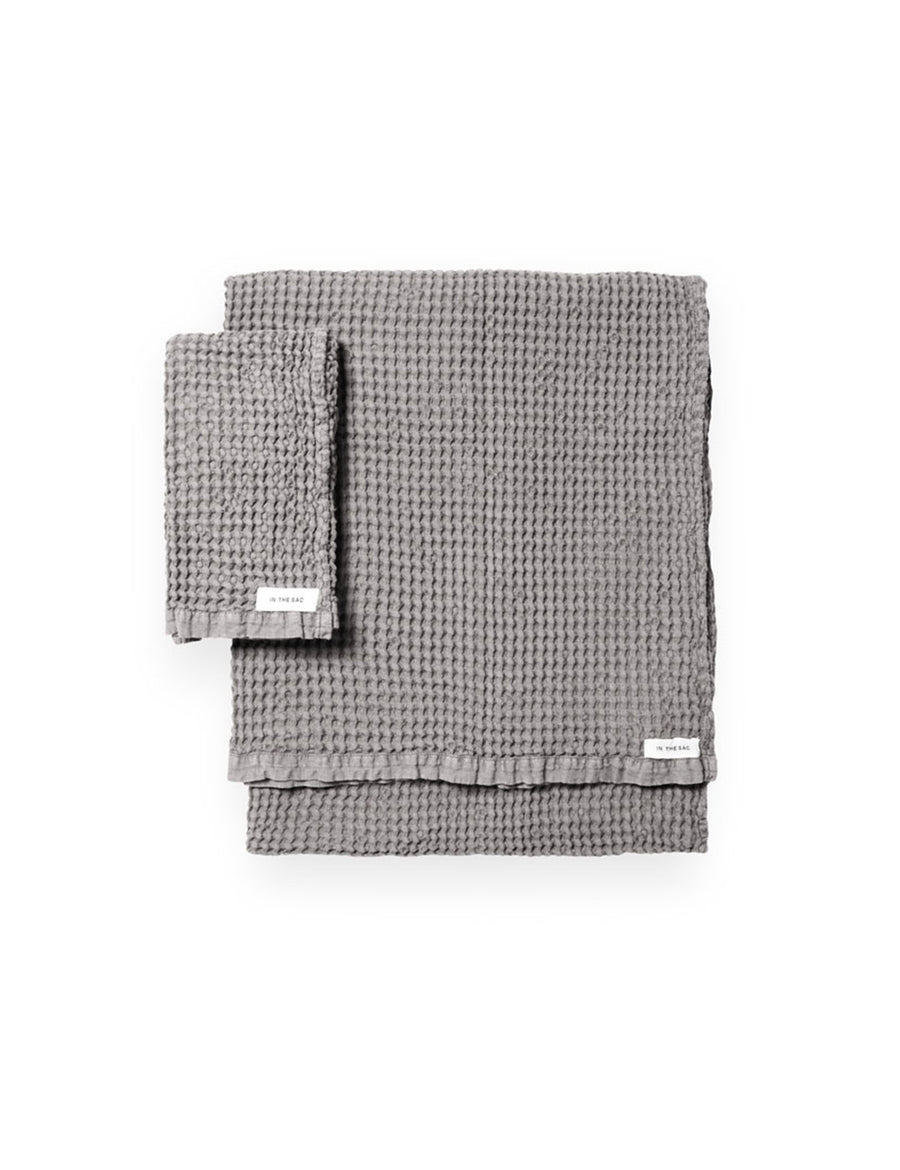stacked photo of linen waffle hand towel in grey colour with matching bath towel