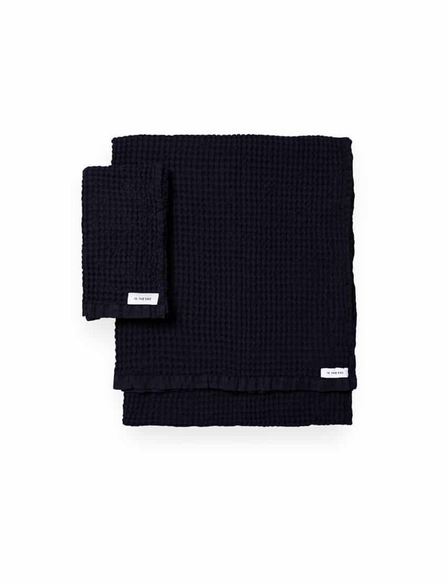 stacked photo of linen waffle hand towel in navy colour with matching bath towel