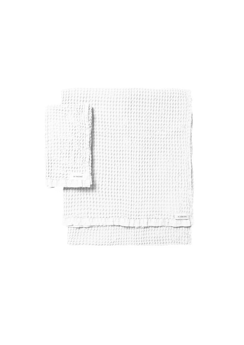 stacked photo of linen waffle hand towel in white colour with matching bath towel